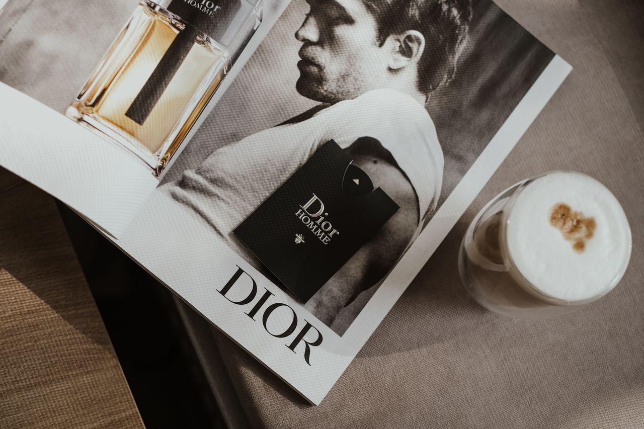 services-01 Elegant flat lay featuring a Dior magazine and a stylish coffee, suggesting luxury and sophistication.
